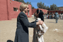 [PHOTO: Mrs. Clinton visits with a young student of the Ait Ameur School in the Berber Village of Morocco]
