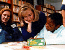 [PHOTO: Hillary Clinton helping students study in an Arkansas public 
school]