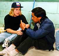 Photo of Tipper Gore with a blink man at a shelter in Honduras