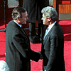 [PHOTO: Bush & Clinton shaking hands]