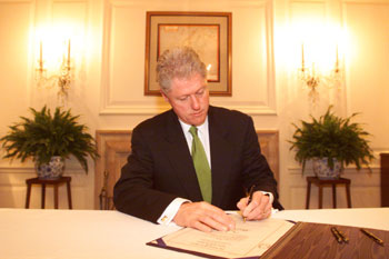 President Clinton signing legislation designating the United States Post Office in Chino Hills, California, as the 'Joseph Ileto Post Office'.