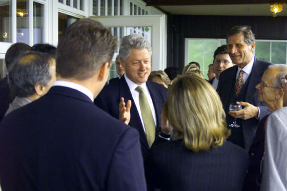 President Clinton converses with guests at a dinner hosted by Chancellor and Mrs. Schroeder at the Rolandsbögen Restaurant in Bonn.