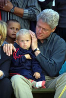 President Clinton comforts a young boy at Stenkovic I refugee camp in Macedonia.
