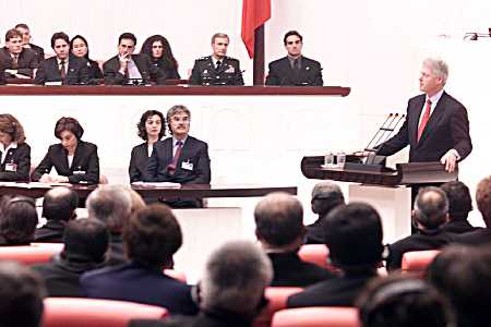 Members listen as the President addresses the Turkish Parliament, officially known as the Turkish Grand National Assembly.