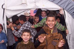 Two boys at the Dogukisla Tent City in Izmit wait for President Clinton to arrive.