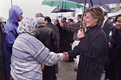 Mrs. Clinton greets a woman at the Dogukisla Tent City.