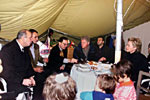 The President and First Lady are invited into a tent for a cup of tea.