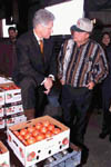 The President stops to speak to a local farmer at the Hermitage Tomato Co-operative in Arkansas; Photo by Ralph Alswnag, November 5, 1999.