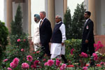 President Clinton and Prime Minister Atal Bihari Vajpayee stroll through the garden following their bilateral meeting en route to the signing ceremony at Hyderabad House, New Delhi.