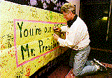 President 
Clinton autographing a banner from some special admirers