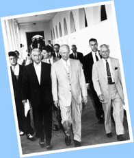 President Eisenhower (center) walks with his Chief of Staff, Sherman Adams - far right.